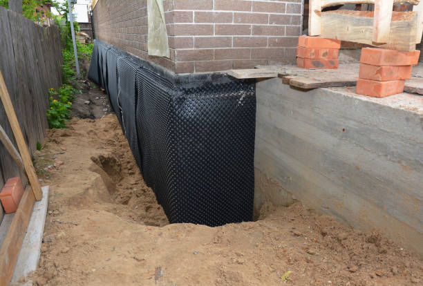 Happy homeowners after waterproofing job in East Concord